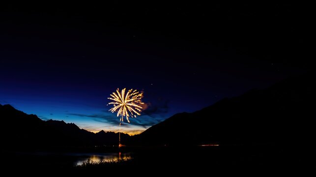 Golden fireworks bursting against a twilight sky, reflecting on a tranquil lake during National Day festivities.