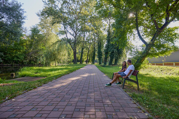 Fototapeta premium Father and daughter spending time together in the park exercising and relaxing.