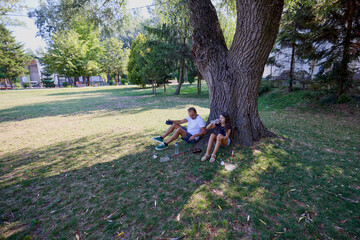 Father and daughter spending time together in the park exercising and relaxing.