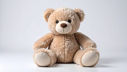 Obraz premium Cute brown teddy bear sitting on a plain background.