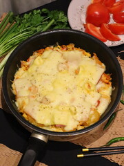 Double cheese pineapple pizza served in a hot pan, rich, cheesy, and delicious with a tropical twist.