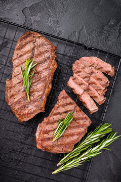 Grilled Top blade steak, shoulder beef meat. black background. top view
