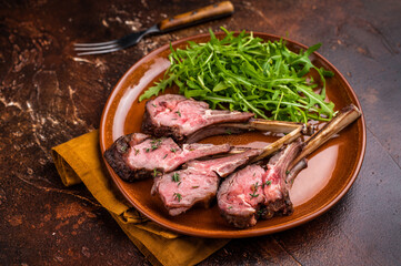 Roasted lamb chop cutlets, mutton meat steaks  with salad. brown background. top view