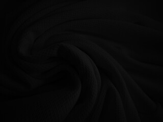 Black crumpled fabric texture. Dark folded cloth background
