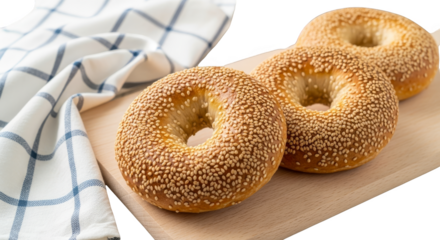 Sesame bagels arranged artfully on wood