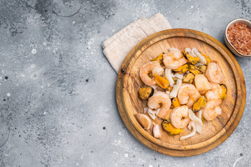 Frozen Raw Seafood Cocktail with Mussels, Clams, Prawns, Shrimps and squid. grey background. top view