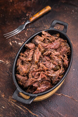 Slow Cooked Pulled Beef, Traditional meat rubbed with spices and smoked. brown background. top view
