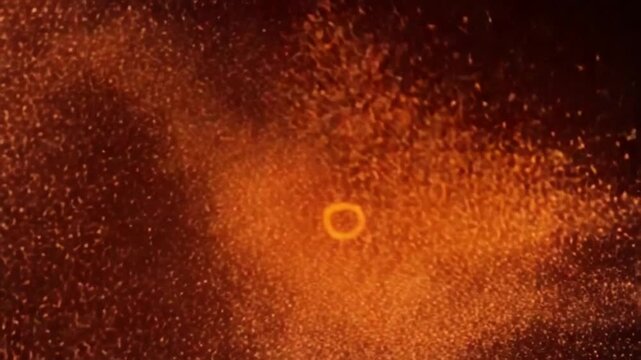 Seamless Loops Burning red hot fire particles. Glowing sparks on a black background. Coals of flame, lava ejecting energy. 4k 60 fps seamless video animation.