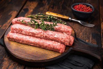 Balkan raw Cevapcici Sausage, fresh Cevapi from mince beef and pork meat. wooden background. top view
