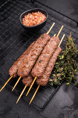 Grilled Cevapcici skewers, Cevapi sausages from mince beef and pork meat. black background. top view