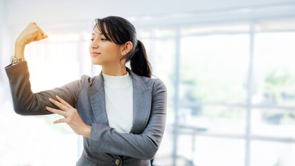 Attractive businesswoman show her power with blur background at office. Confidence leader in job and management concept.	
