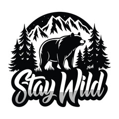 Black Bear Between Pine Trees and Mountains with 'Stay Wild' Art