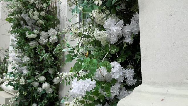 Artificial white flowers and Eucalyptus. The decorated facade of the building