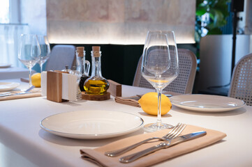 An Elegant Dining Table Setting featuring Olive Oil and Lemons for a Stylish Experience