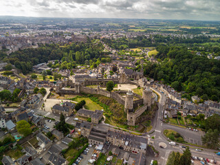 Obraz premium Aerial view of Fougères, Brittany, France, showcasing the town’s historic streets and its iconic medieval castle dominating the skyline.