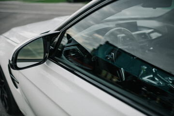 Close-Up of White Car Side Mirror and Window
