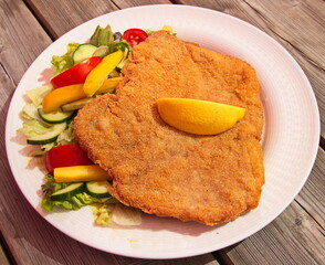 Pork cutlet with vegetable salad in a restaurant in Austria, Europe
