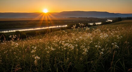 Obraz premium Golden Sunset Over Tranquil River Landscape with Wildflowers and Distant Hills.