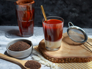 Traditional Thai tea brewing. Hot orange tea with condensed milk.