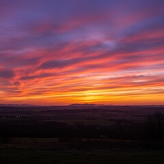 Obraz premium Vibrant Sunset Landscape with Colorful Clouds