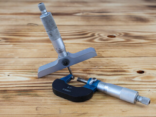 A comprehensive display of precision measuring tools, including a depth micrometer and an external...