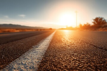 Blurred highway surface in southern desert landscape at sunset with rays of sunlight