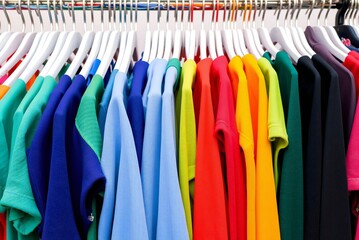 Fototapeta premium Clothing arranged in on hangers