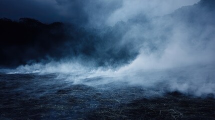 Obraz premium The vast expanse of pitch-black land, from which white smoke rises, creates a strong atmosphere of mystery and intrigue, suitable for visual storytelling or art installation design.
