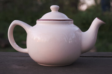 Classic White Teapot on Wooden Surface