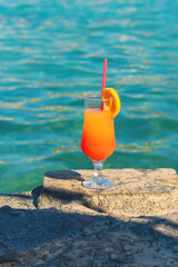 Cocktail on the sea background. Selective focus.