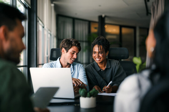 Busy smiling executive business team using digital devices in office. Diverse professional people