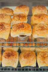 Bolen cake with grated cheese topping arranged on a display case