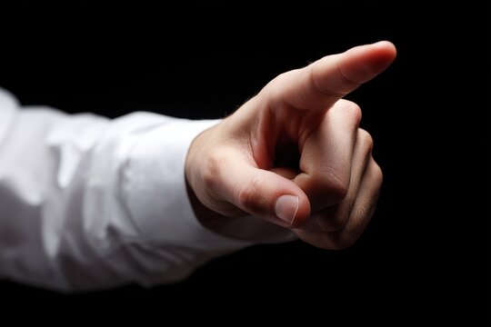 A hand in a white shirt makes a finger gun gesture against a black background