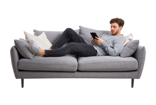 Young Man Relaxing on Sofa with Tablet: Leisure and Digital Comfort at Home isolated on a transparent background - Powered by Adobe