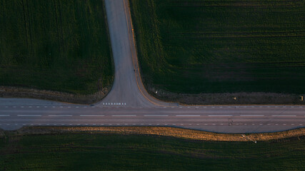 Drone view of empty roads amidst agricultural field