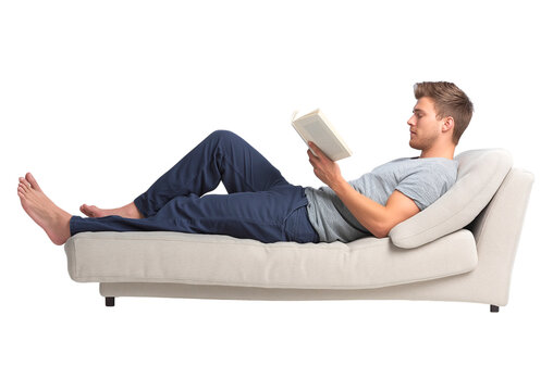 Relaxed Young Man Reading Book on Sofa isolated on a transparent background