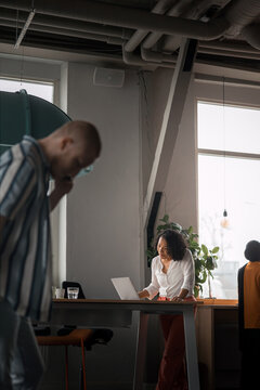 Concentrated female entrepreneur using laptop while working in office
