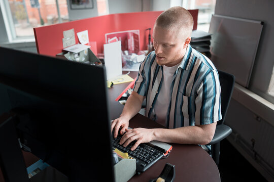 High angle view of male entrepreneur typing on keyboard while working in office