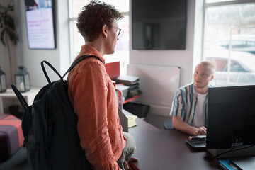 Male business expert talking with male colleague while leaving from office