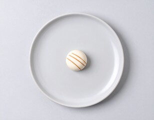 Single macaron on a plate from above 
