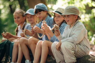 Making the knot on the rope, sitting. Group of children in the forest on a hike