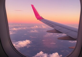 Fototapeta premium ピンクの翼と夕焼け空 飛行機窓からの景色