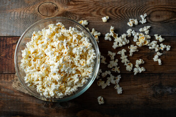 Pop corn on wood color background.Food and snack concepts ideas.Minimal style top view mockup