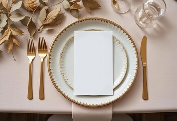 Elegant Table Setting with Blank White Card and Gold Cutlery