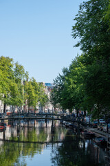 Obraz premium Beautiful cityscape view of the city of Amsterdam as seen from the canal and bridges.