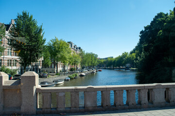 Beautiful cityscape view of the city of Amsterdam as seen from the canal and bridges.