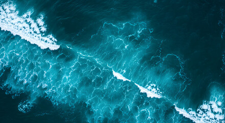 Aerial top view of ocean waves with turquoise blue water and white sea foam abstract backgronud
