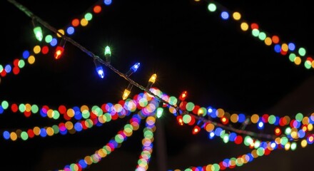 Vibrant Multicolored Christmas String Lights with Sparkling Bokeh Effect Illuminating a Festive Night