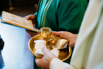 Christening in the church - priest holding stuff to baptism
