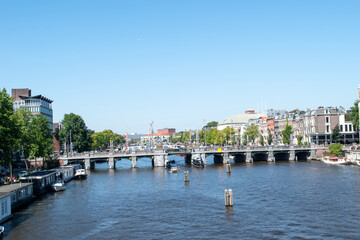 Beautiful cityscape view of the city of Amsterdam as seen from the canal and bridges.